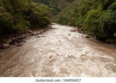 Turbulent waters of the Urubamba or Vilcanota river, crossing the Amazon cloud forest, as it passes through the town of Aguas Calientes, near Machu Picchu, Sacred Valley of the Incas, Peru. - Shutterstock ID 1969034017