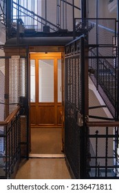 TURIN, ITALY - August 21, 2021: Antique Wooden Elevator In A Metal Shaft.