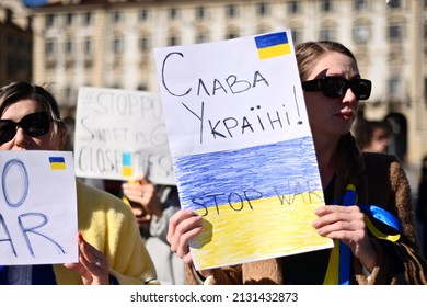 TURIN, ITALY - FEBRUARY 26: People Holds A Protest Sign And Ukrainian Flag For Protest In Support Of Ukraine Near The Russian Embassy On February 26, 2022 In Turin, Italy. 