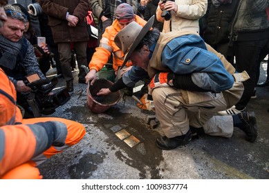 TURIN, ITALY - JANUARY 18, 2018: Artist Gunter Demnig Lays One Of His Stumbling Blocks At The 'Memory Blocks' Performance In Turin, Italy. He Started  In 1996 To Remember The Victims Of Nazism.