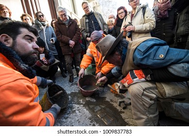 TURIN, ITALY - JANUARY 18, 2018: Artist Gunter Demnig Lays One Of His Stumbling Blocks At The 'Memory Blocks' Performance In Turin, Italy. He Started  In 1996 To Remember The Victims Of Nazism.