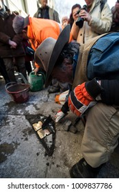 TURIN, ITALY - JANUARY 18, 2018: Artist Gunter Demnig Lays One Of His Stumbling Blocks At The 'Memory Blocks' Performance In Turin, Italy. He Started  In 1996 To Remember The Victims Of Nazism.