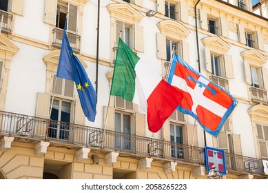 Turin, Italy. May 12, 2021. The flag of Europe, Italy and the Piedmont Region flutters on the facade of the historic building seat of the Government of the Piedmont Region in Piazza Castello.