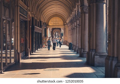 Turin, Italy, September 10, 2018: People are walking down the streets with buildings with stores and arcade columns colonnade archways portico in historical centre, Piedmont