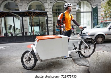 Turin, Italy - September 25, 2017: TNT Postman with his cargo bike 