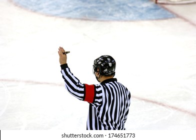 TURIN, ITALY-FEBRUARY 18, 2006: Ice Hockey referee with the Olympic rings on the background, at the Winter Olympic Games of Turin 2006.