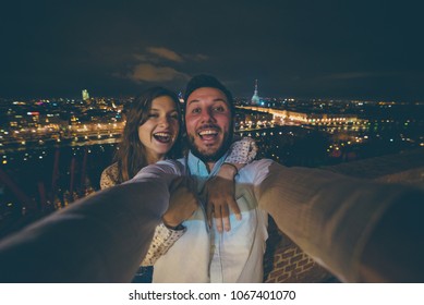 Turists In Turin (TORINO) Italy Take Photo Romantic In Front Of The City Lights Landscape And Mole Antonelliana 