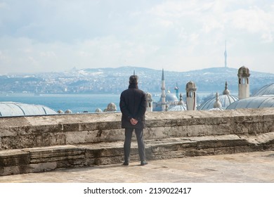 İSTANBUL, TURKEY - 03.15.2022: The Man Watches The View Of Istanbul From The Garden Of The Süleymaniye Mosque. Selective Focus On Man.