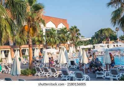 Turkey, Antalya, Lara Beach - July 9, 2022:  Lots Of Sun Beds By The Pool In Lara Beach Topkapi Palace Hotel. People Relaxing By The Pool