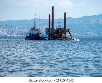 Karşıka, İzmir Turkey,
August 2022
Garbage Collection At Sea, Large Construction Machine Empties The Garbage At The Bottom To Another Garbage Collection Ship