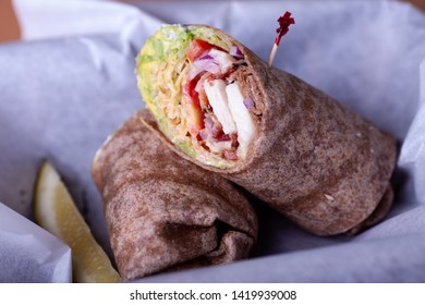 Turkey Bacon Ham Avocado Lettuce And Onion On A Whole Wheat Wrap