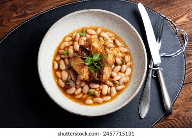 Turkey, beans, and sun-dried tomatoes stew - a hearty protein-rich dish. Traditional rural kitchen concept. A manually taken photo, not AI - Powered by Shutterstock