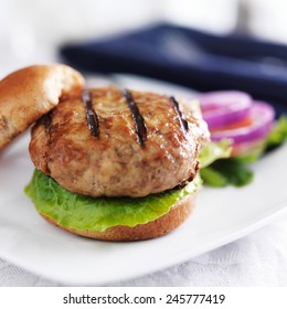 Turkey Burger On Bun With Lettuce And Fixings Close Up