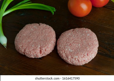 Turkey Burger Patties. Raw Ground Turkey Formed Into Hamburger Patties. Grade A Turkey Ground In A Meat Grinder Mixed W/ Seasonings & Spices & Garlic & Shot On Wooden Block. Sold At Butcher Shops.