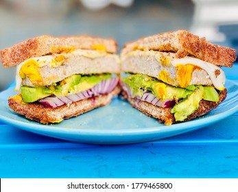 Turkey Burger Sandwich Cut In Half On Blue Plate Healthy Eating