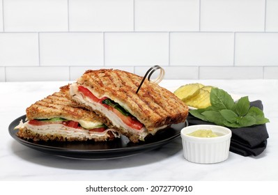 A Turkey Or Chicken, Basil, Provolone Cheese And Tomato Panini On Healthy Multi-grain Bread.