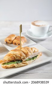 Turkey Croissant With Coffee And Sweet. On Wooden White Background. Close Up