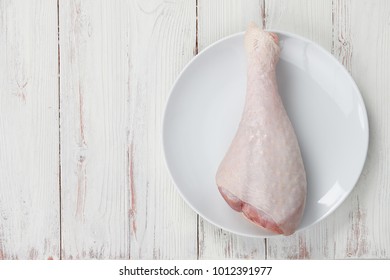 Turkey Drumstick With Skin In Big Plate Isolated On White Background