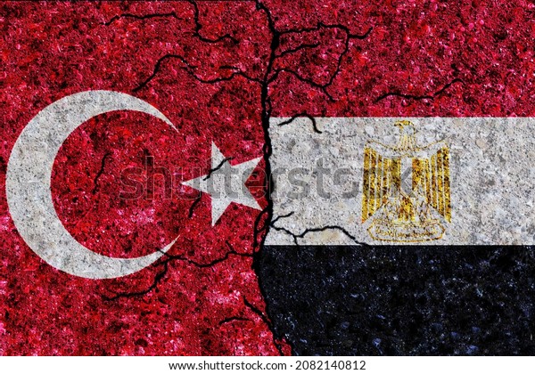Turkey and Egypt painted flags on a wall with\
grunge texture. Turkey and Egypt conflict. Egypt and Turkey flags\
together. Turkey vs\
Egypt