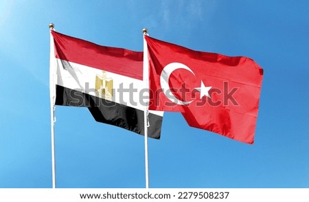 Turkey flag and Egypt flag on cloudy sky. waving in the sky