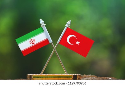 Turkey And Iran Small Flag With Blur Green Background