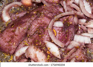 Turkey meat cut into pieces and marinated in red wine with onions and spices. Close-up, surface texture. - Powered by Shutterstock