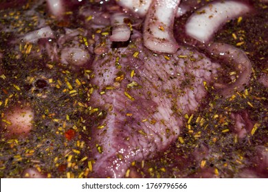 Turkey meat cut into pieces and marinated in red wine with onions and spices. Close-up, surface texture. - Powered by Shutterstock