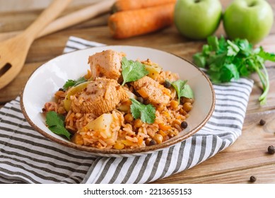 Turkey Pilaf. Large Plate Of Second Course. A Home-cooked Meal. Large Pieces Of Turkey Meat In Rice, Spices And Roasted Carrots And Onions. The Dish Is Garnished With Fresh Cilantro Leaves.