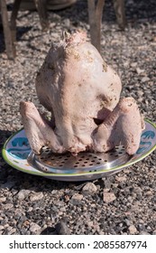 A Turkey Is Placed On The Rack And Ready To Be Lowered Into The Deep Fryer For Frying.