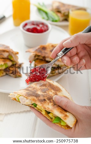 Turkey quesadillas with currant sauce, fresh orange juice, woman, preparing for eat