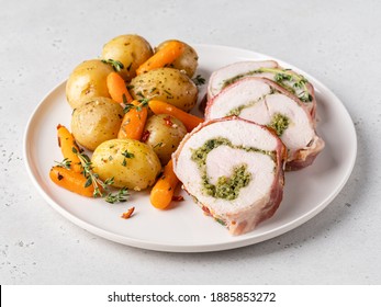 Turkey Roll (roulette Or Meat Loaf) With Pesto Wrapped In Bacon Slices With Baked Baby Carrots And Potato In Herbs. Tasty Homemade Dinner Or Supper. Delicious Healthy Food. Close Up.