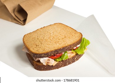 Turkey Sandwich On Wax Paper With Brown Paper Bag  