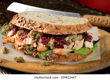 Turkey sandwich with stuffing and cranberry sauce. Freshly made from Christmas turkey leftovers on crusty wholemeal bread.