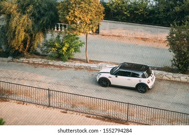 Kusadası, Turkey - September 12, 2019: Top View Of White Color 2004 Mini One Hatch Mini Cooper Car Parking On Street