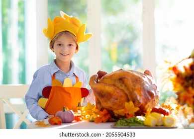 Turkey For Thanksgiving. Family Cooking Festive Dinner. Grandmother And Child Roast Meat In Decorated Kitchen. Mother And Kid Cook In Autumn. Grandparents Visit. Fall Season Food.