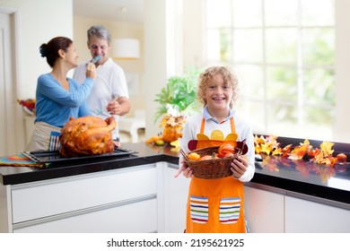 Turkey For Thanksgiving. Family Cooking Festive Dinner. Mother, Father And Child Roast Meat In Decorated Kitchen. Mom, Dad And Kid Cook For Autumn Holiday Meal. Fall Season Food And Home Decoration