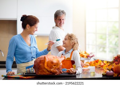 Turkey For Thanksgiving. Family Cooking Festive Dinner. Mother, Father And Child Roast Meat In Decorated Kitchen. Mom, Dad And Kid Cook For Autumn Holiday Meal. Fall Season Food And Home Decoration