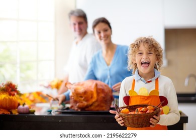 Turkey For Thanksgiving. Family Cooking Festive Dinner. Mother, Father And Child Roast Meat In Decorated Kitchen. Mom, Dad And Kid Cook For Autumn Holiday Meal. Fall Season Food And Home Decoration