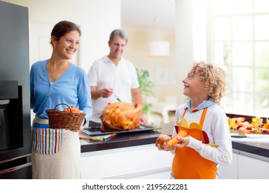 Turkey For Thanksgiving. Family Cooking Festive Dinner. Mother, Father And Child Roast Meat In Decorated Kitchen. Mom, Dad And Kid Cook For Autumn Holiday Meal. Fall Season Food And Home Decoration