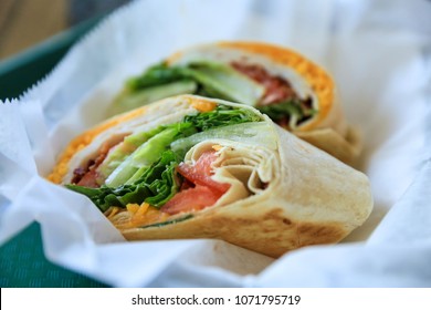 Turkey Wrap With Cheese, Lettuce And Sliced Tomatoes, Served In A Basket