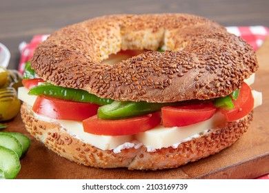 Turkish Bagel Simit Sandwich. Vegan Bagel Made At Home With With Cheese, Tomato And Cucumber On A Wooden Background. Fast Turkish Breakfast