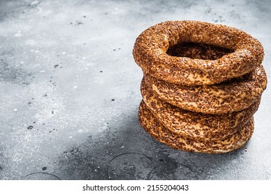 Turkish Bagel Simit with sesame traditional pastry. Gray background. Top view. Copy space.