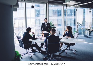 Turkish businessman making training conference meeting with male and female employees explaining statistic information from corporate report, group of experienced people discussing strategy teamwork - Shutterstock ID 1751367647