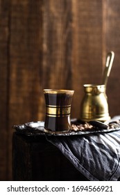 Turkish Coffee Cup With Vintage Copper Stovetop Coffee Pot Shot On A Dark Textured Wooden Background Backlit 