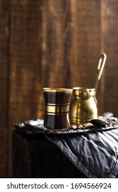 Turkish Coffee Cup With Vintage Copper Stovetop Coffee Pot Shot On A Dark Textured Wooden Background Backlit 