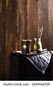 Turkish Coffee Cup With Vintage Copper Stovetop Coffee Pot Shot On A Dark Textured Wooden Background Backlit 