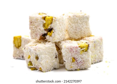 Turkish Delight Double Roasted Sultan Wick with Coconut Flakes, isolated on a white background. Close-up pistachio Turkish delight. Traditional Turkish cuisine delicacies.