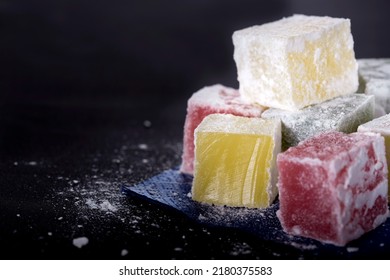 Turkish Delight Pieces On Blue Paper Napkin Over Black Background