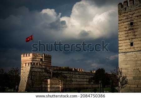 Turkish flag on fortress, turkish flag on top of the stone wall castle istanbul in night, medieval war history background concept, 