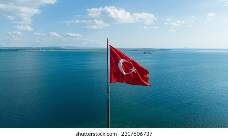 Turkish flag. Red Turkish flag waving on the sea.